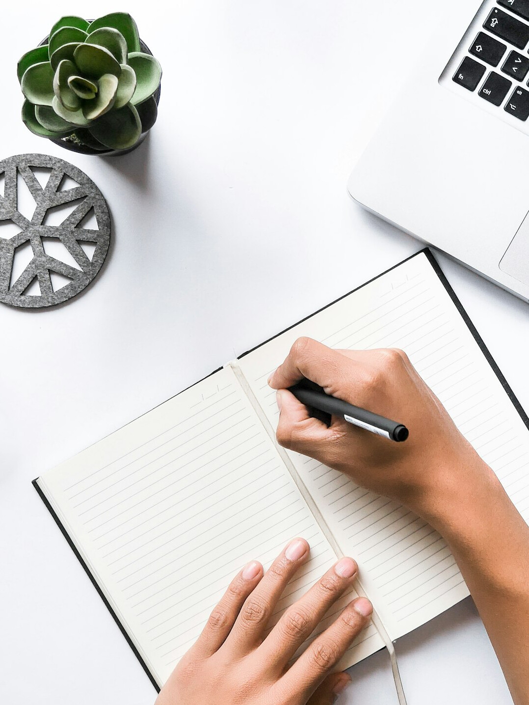person writing budget notes